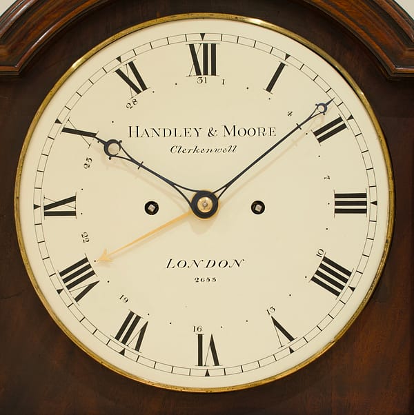 georgian-longcase-clock-handley-moore-london-dial image of a convex circular white painted clock dial by handley and moore of london with blued steel hands and sweep centre date work