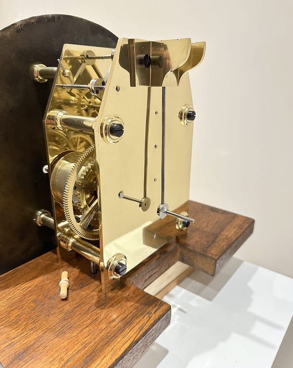 victorian-mahogany-floorstanding-regulator-longcase -clock-movementback Image showing the shaped brass plates and screwed pillars of a very fine quality English regulator clock dating 1870, in fully restored condition.
