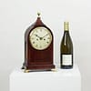 durden-london-mahogany-fusee-mantel-clock-main-image-size The small sized antique mantel clock pictured next to a wine bottle to give an indication of size