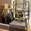london-walnut-quarter-chiming-longcase-grandfather-clock-movement Deatailed image of the quarter chiming movement showing curled blued steel gongs