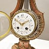 small-french-marble-lyre-mantel-clock-dial Image of the convex enamel dial with floral swags and roman numerals
