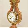 small-french-marble-lyre-mantel-clock-side-view A French Marble And Ormolu Mount Lyre Mystery Mantel Clock, angled view image