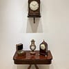 rosewood-bracket-clock-adams-london-showroom showroom image of antique bracket clock and mantel clock display on a Regency card table
