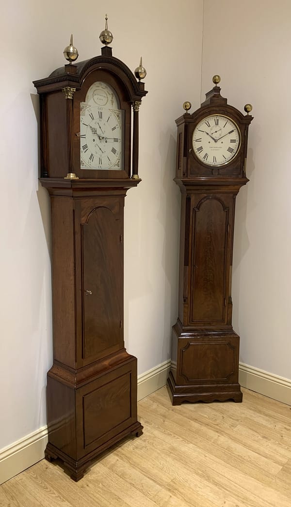 georgian-mahogany-longcase-antique-clock-painted-dial-showroom-view A fine quality flame mahogany 8 day longcase clock by John Startridge of Cowes c.1795 photographed in Story Antique Clocks showroom