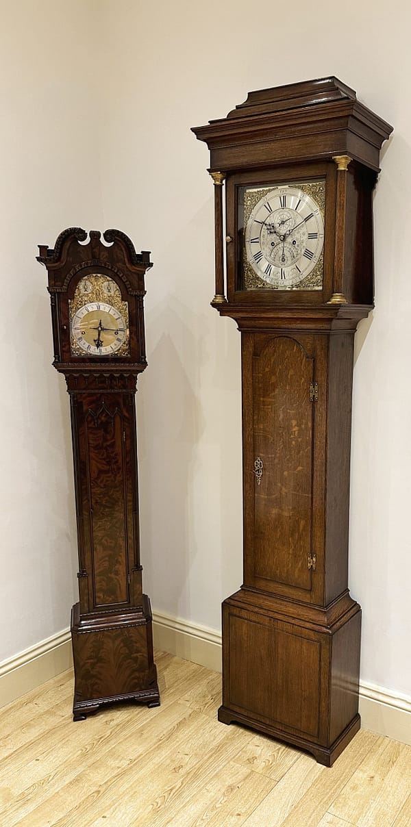 mason-bawtry-georgian-oak-brass-dial-longcase-grandfather-clock-showroom A showroom image of the mason of Bawtry longcase clock stood next to a small grandmother clock from the Victorian period