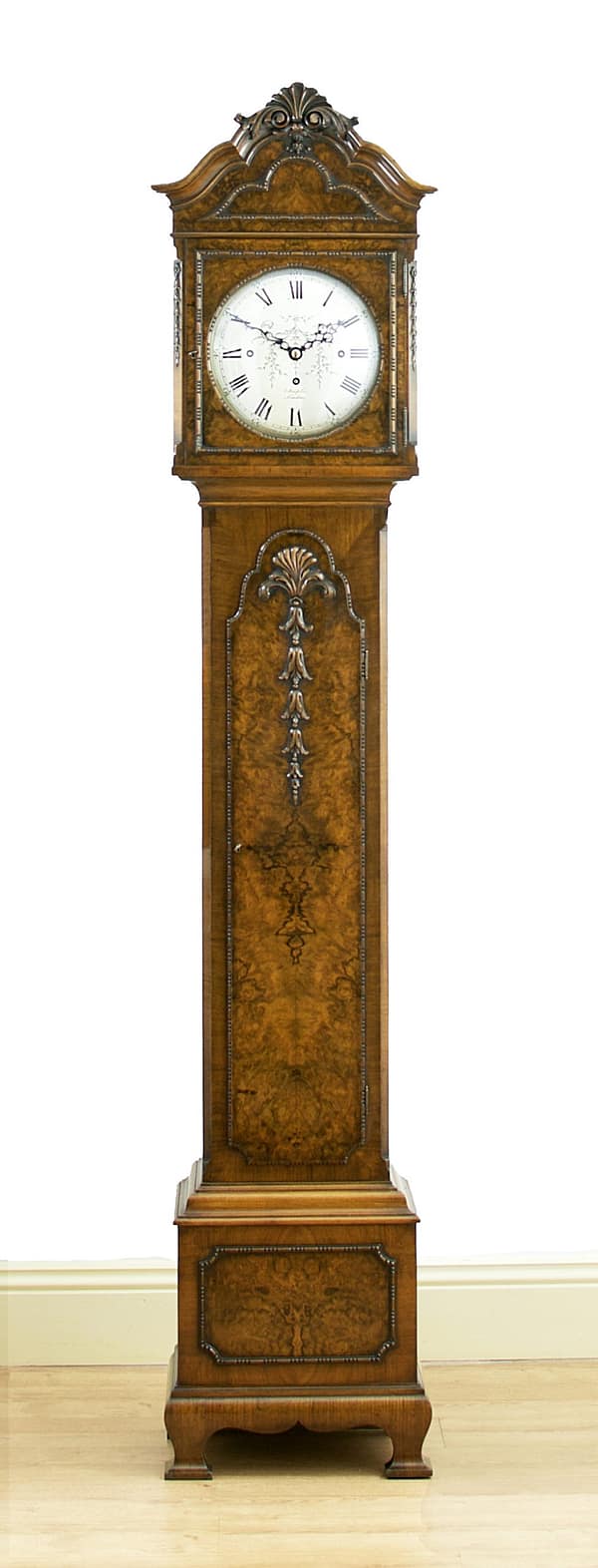 london-walnut-quarter-chiming-longcase-grandfather-clock-master-showroom A high quality, small proportioned, Westminster chiming longcase / grandfather clock by Maple of London. image of the clock in a showroom setting