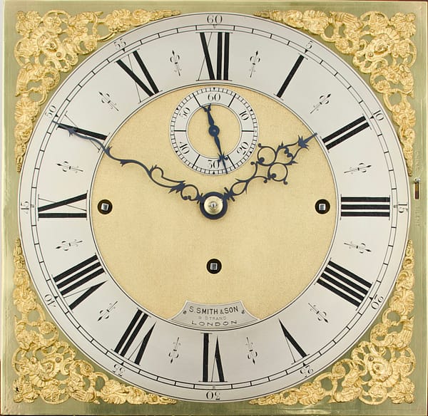smith-london-quarter-chiming-longcase-clock-dial A finely executed square brass clock dial with silvered engraved chapter ring and gilded spandrels to the corners.