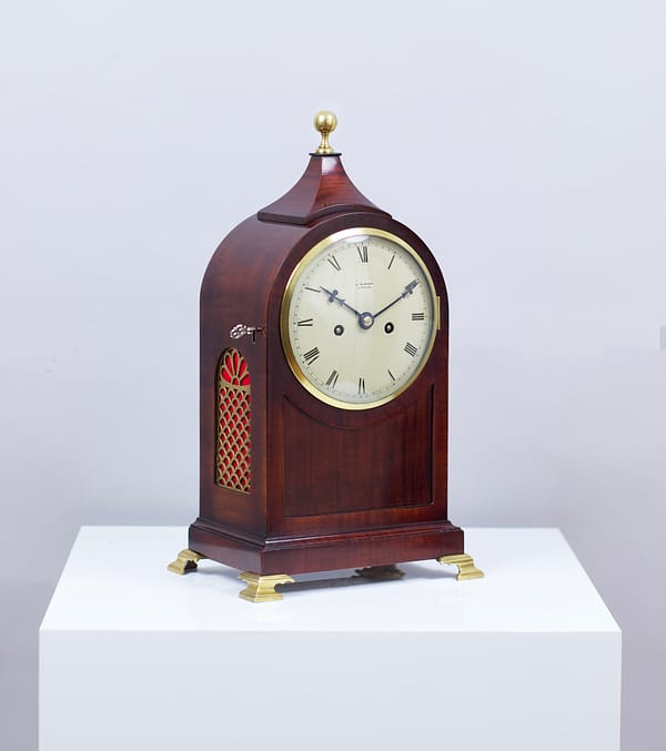 durden-london-mahogany-fusee-mantel-clock-side-view A picture of the Durden antique mantle clock pictured on white plinth at a side angle.