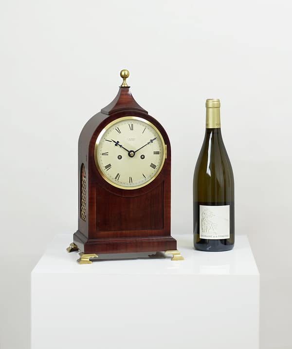 durden-london-mahogany-fusee-mantel-clock-main-image-size The small sized antique mantel clock pictured next to a wine bottle to give an indication of size