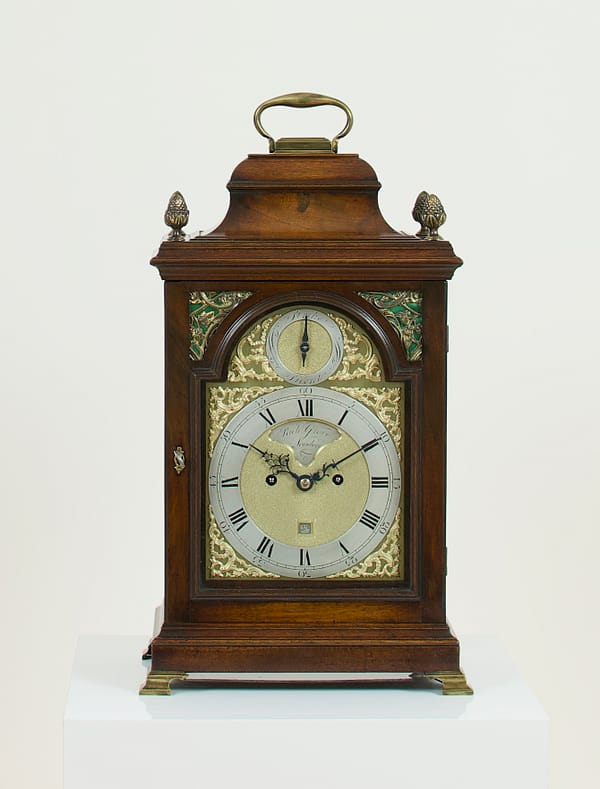 antique-bell-top-georgian-bracket-clock-london An image of a classic Georgian mahogany bracket clock with a brass dial and mahogany case.