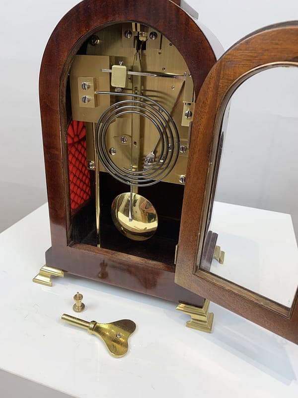 durden-london-mahogany-fusee-mantel-clock-movement-side A detailed image of the double fusee antique mantel clock movement, featuring the original winding key.