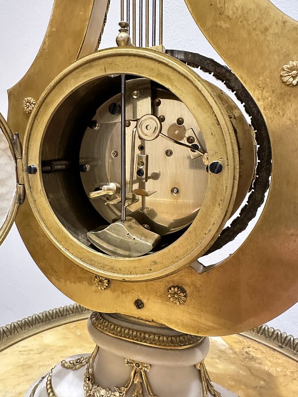 french-white-marble-lyre-mantel-clock-movement-detail image of the 8 day fully restored circular spring driven antique french mantle clock movement.