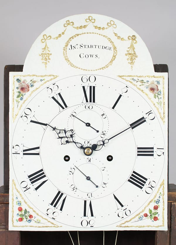 georgian-mahogany-longcase-antique-clock-painted-dial-image A fine quality flame mahogany 8 day longcase clock by John Startridge of Cowes c.1795. Painted dial image with roses to the corners and Roman and Arabic chapter ring.