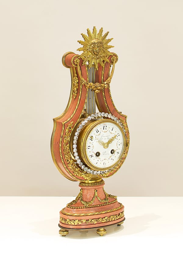 small-french-marble-lyre-mantel-clock-showroom Side view of a French Marble And Ormolu Mount Lyre Mystery Mantel Clock.