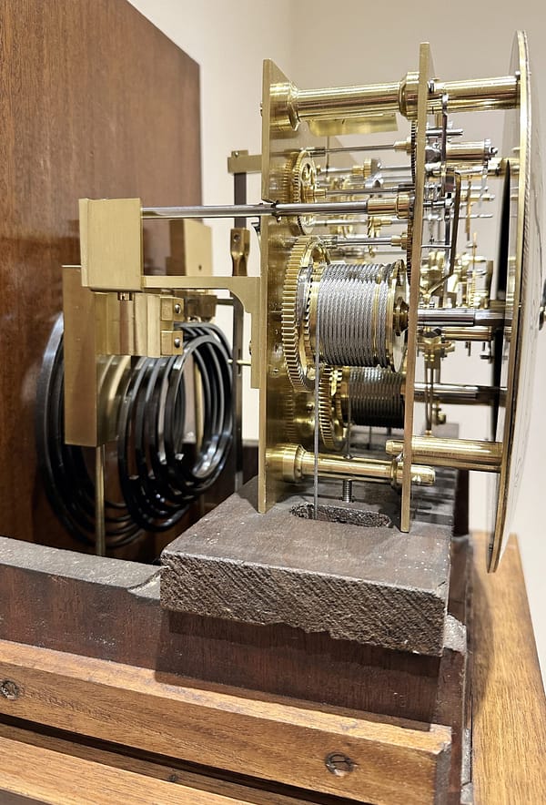 london-walnut-quarter-chiming-longcase-grandfather-clock-movement Deatailed image of the quarter chiming movement showing curled blued steel gongs