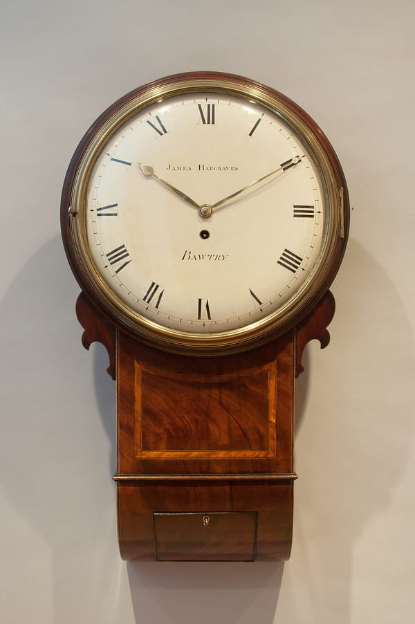 hargraves-bawtry-georgian-mahogany-fusee-drop-dial-wall-clock-showroom-master Image of the clock in a showroom setting