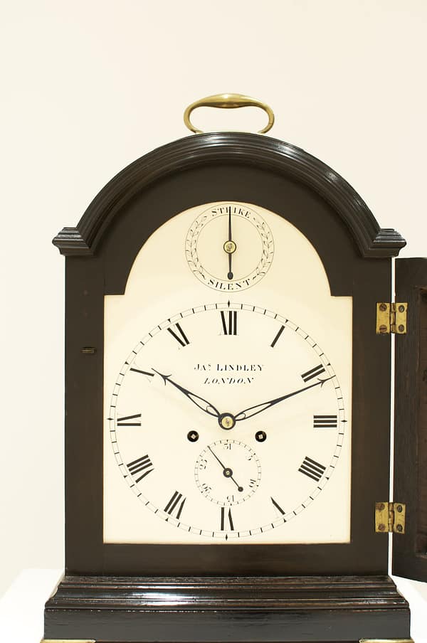 london-georgian-single-pad-top-fusee-bracket-table-clock-dial A fine and attractive example of an ebonised bracket clock with its original matching wall bracket. Made by the eminent maker J Thwaites of London and retailed by James Lindley of London, showing image of painted white dial signed to the centre