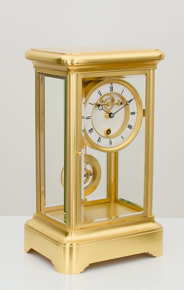 french-four-glass-year-duration-side-1 side view showroom image showing the bevelled edge glass of a superior quality, rare French gilt brass four-glass mantel timepiece, of one year duration dating to the late 19th century.