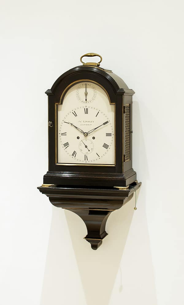 london-georgian-single-pad-top-fusee-bracket-table-clock-main A fine and attractive example of an ebonised bracket clock with its original matching wall bracket. Made by the eminent maker J Thwaites of London and retailed by James Lindley of London.